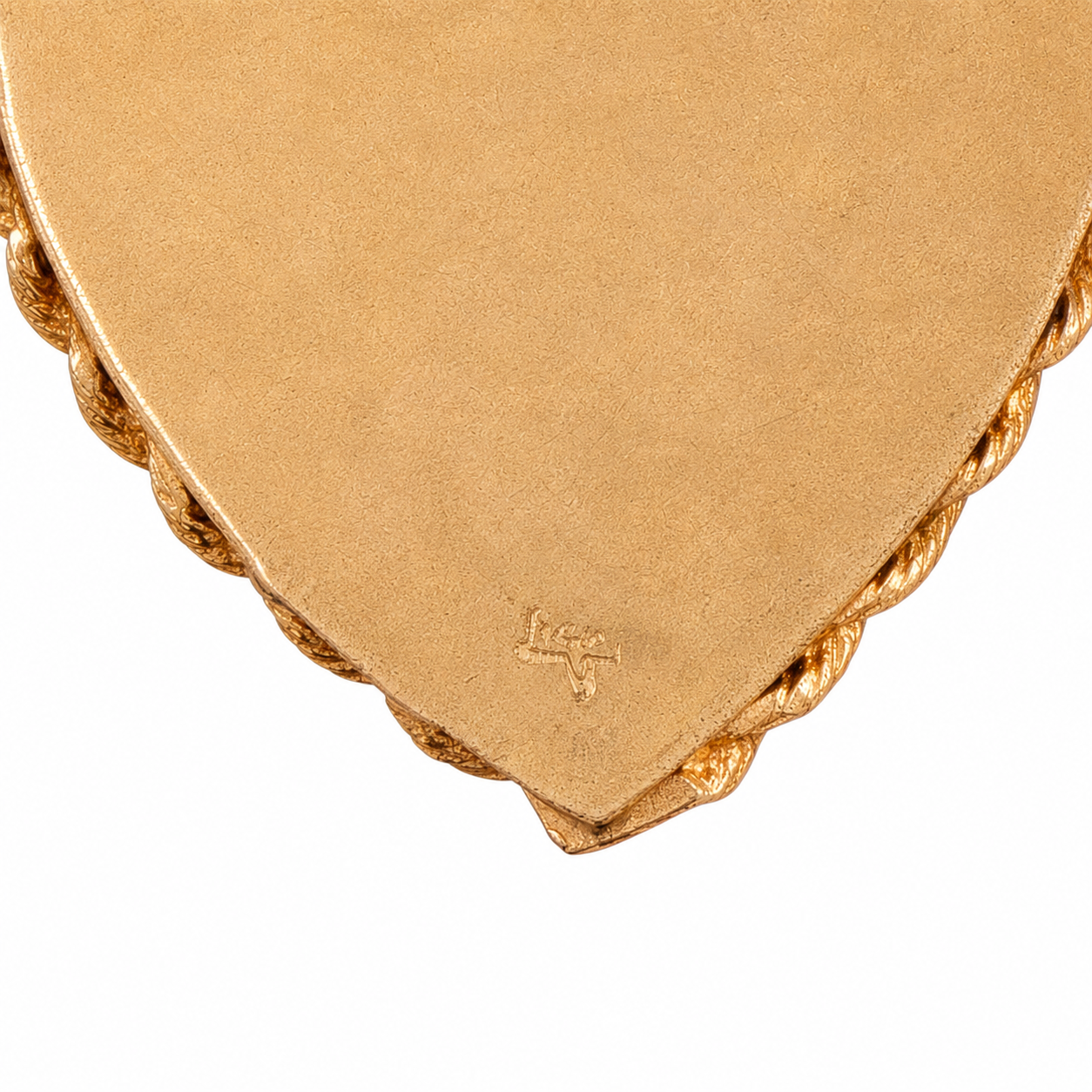 Close up of 14K hallmark stamped on reverse of vintage gold heart pendant