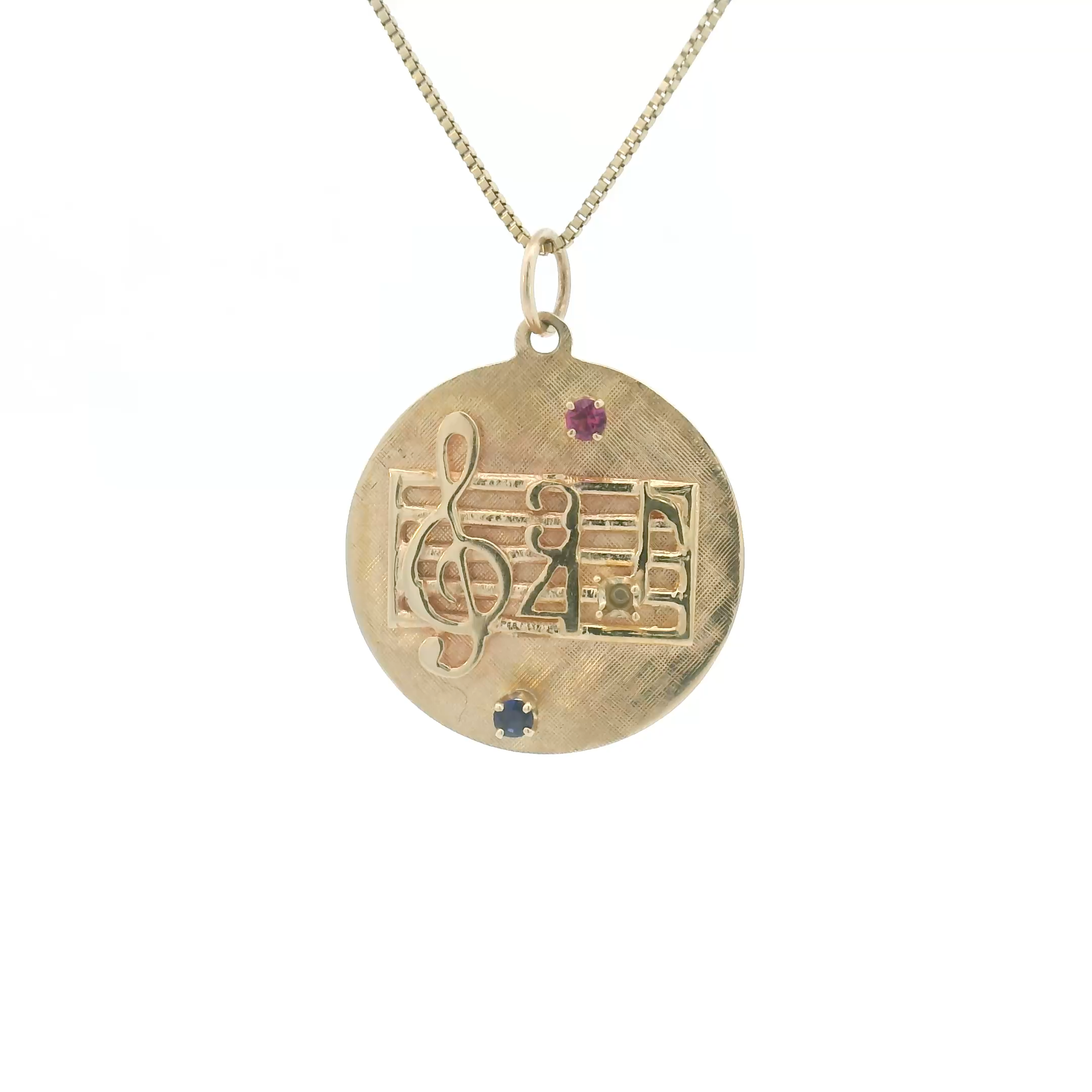 vintage 1950s ruby music charm in 14 karat yellow gold with cabochon stone