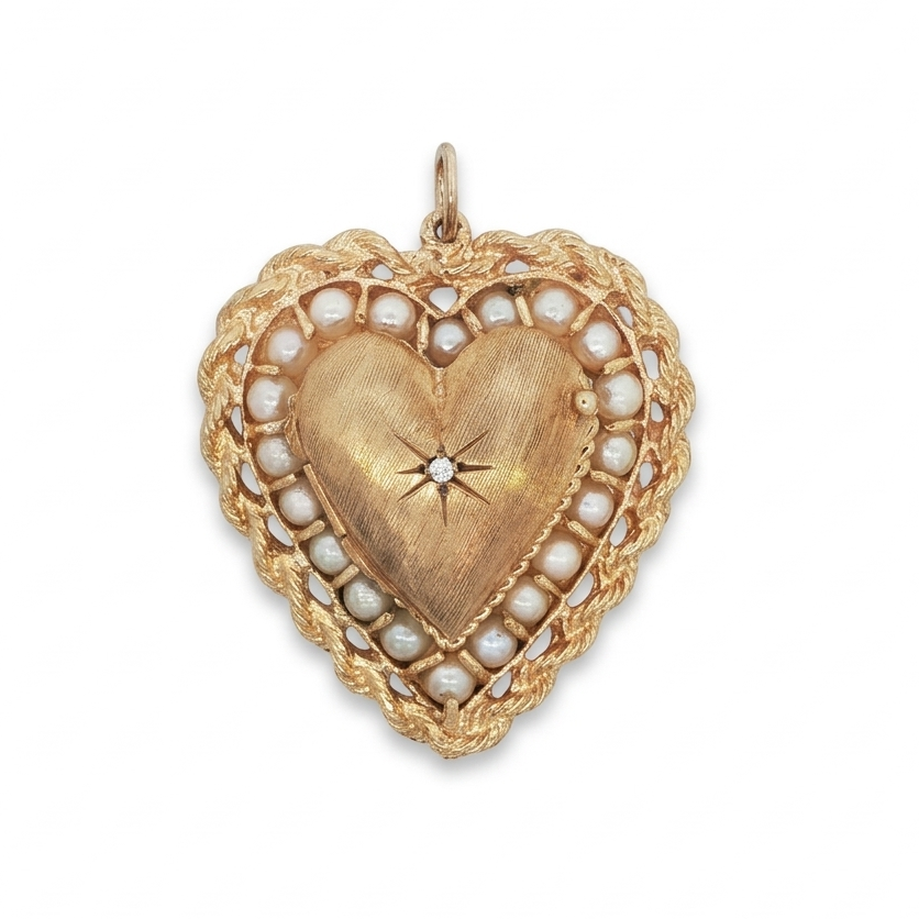 14 karat yellow gold 1970s heart locket with pearl halo and brushed center, front view