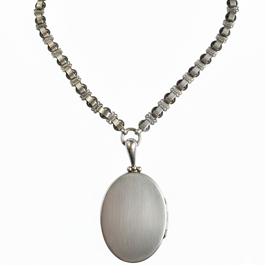 Close-up of ornate floral engraved sterling silver locket from the 1890s