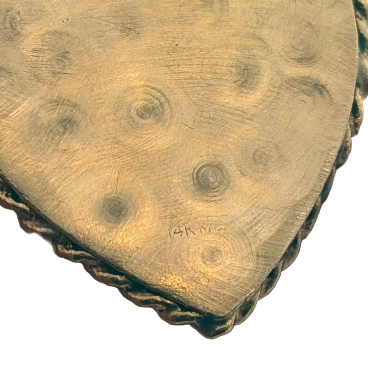 Macro close-up of 14K hallmark stamp on vintage gold heart locket