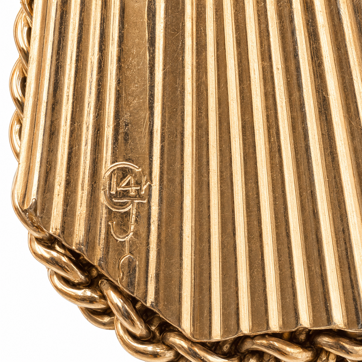 Detail of the 14K stamp and unidentified maker's mark on the locket's back.