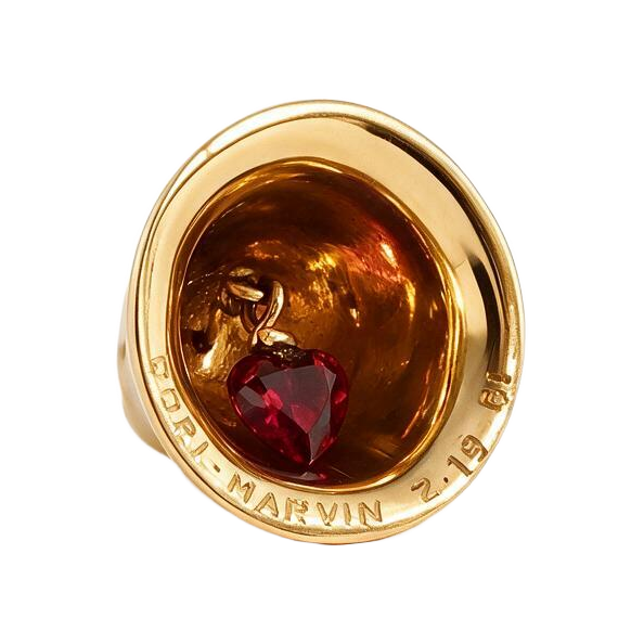 Underside of 14k gold bell charm with ruby heart clapper and original engraved names and date on the rim