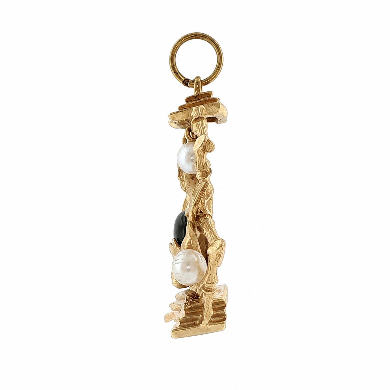 Side profile of vintage gold Buddha charm showing deep casting and pearl on bamboo frame