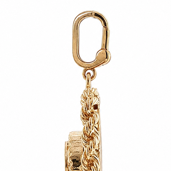 Side view of vintage gold heart locket and close-up of clip bail