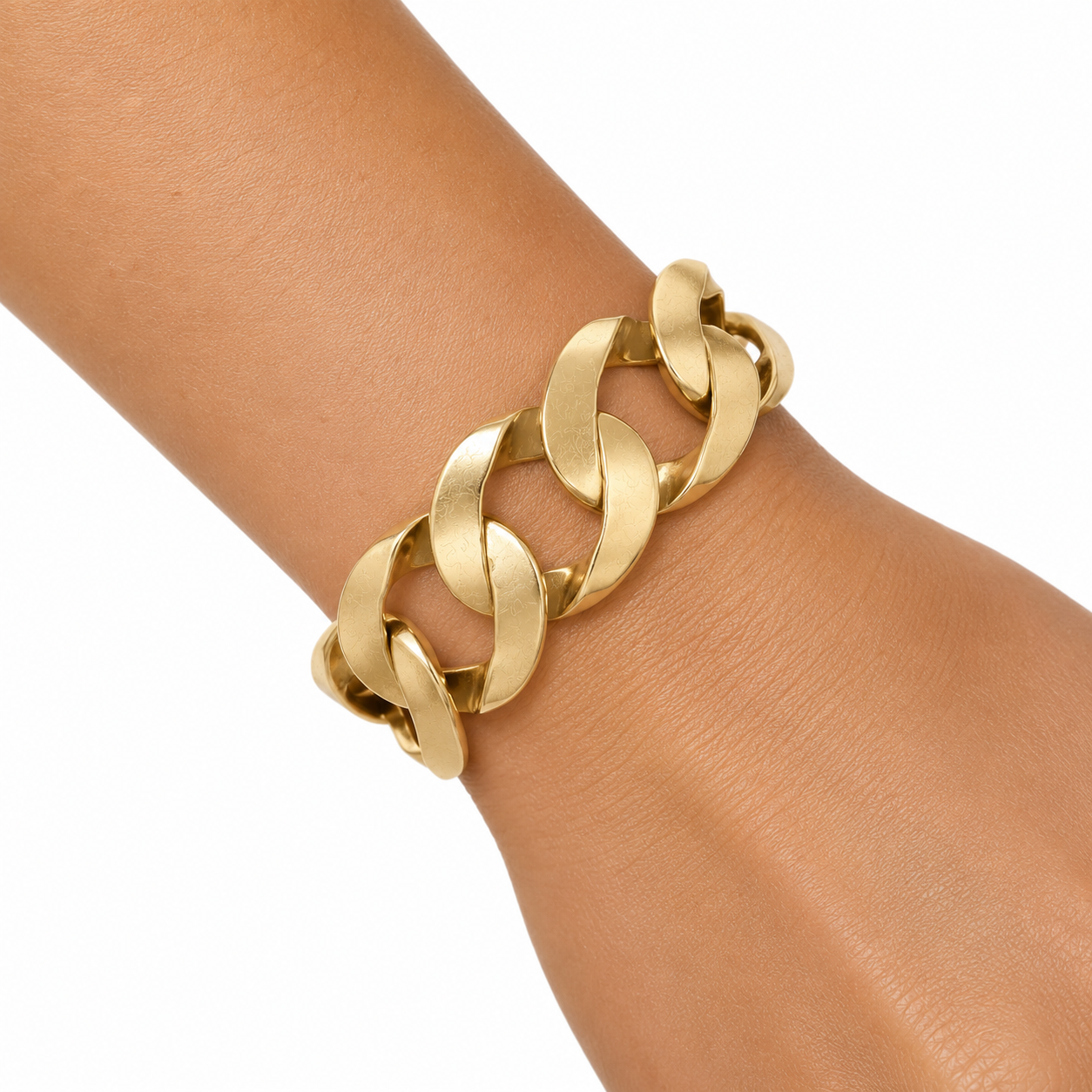 Vintage yellow gold wide curb link bracelet worn on wrist, showing inch-wide links and drape