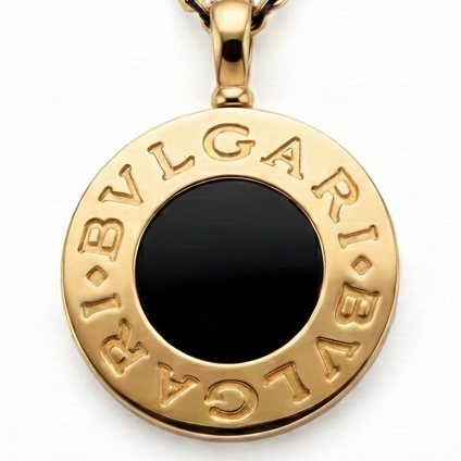 Bulgari necklaces in 18k gold, and black onyx displayed with a model wearing a gold necklace.