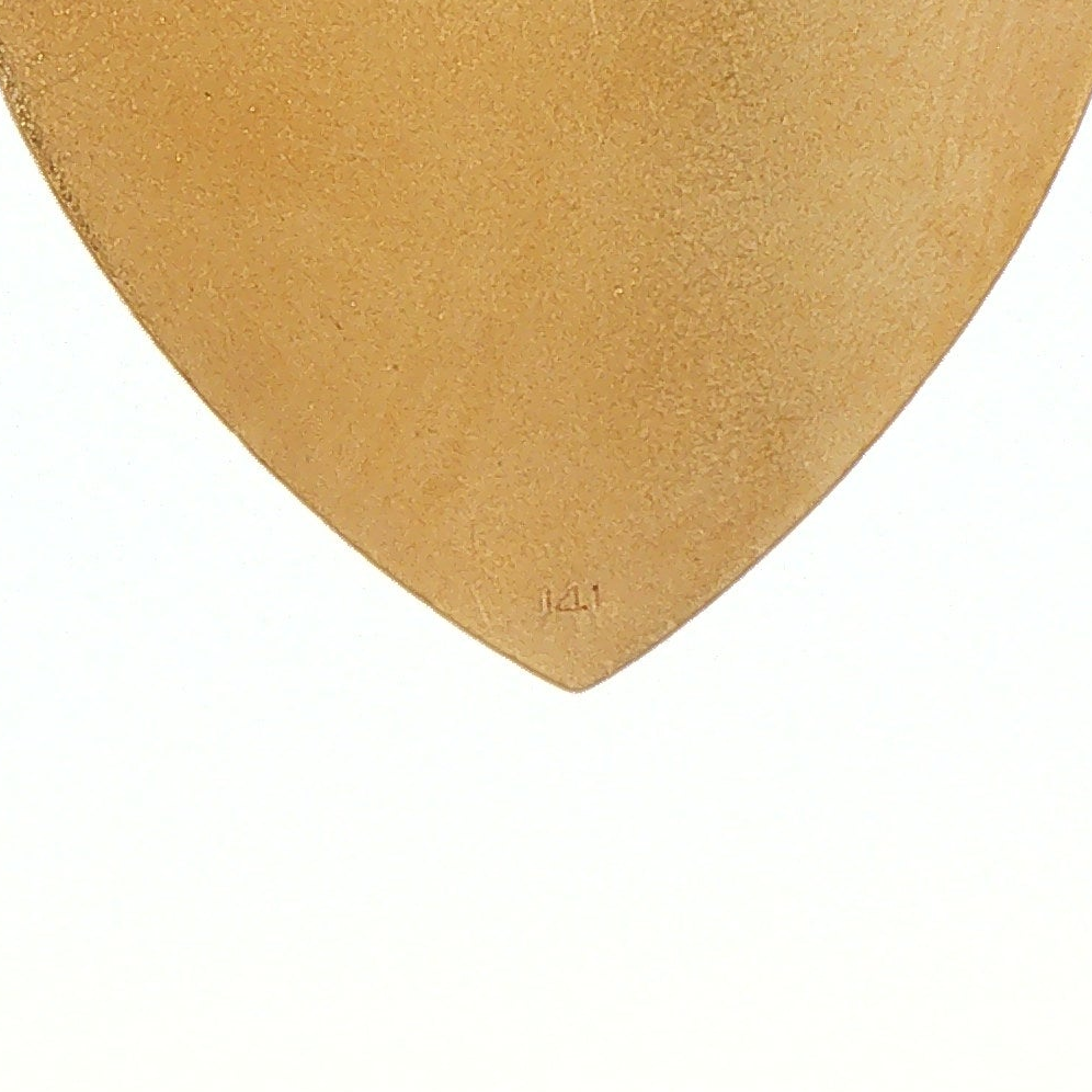 Close-up of hallmark area on 14 karat gold engine-turned heart pendant, lower reverse detail