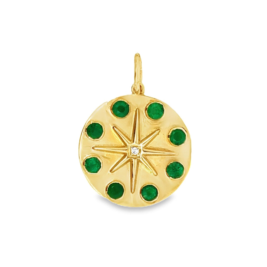 Gold pendant with green gemstones on a white background
