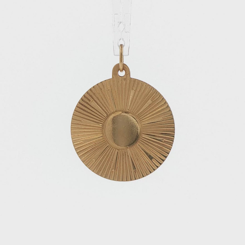 Video of a 14k yellow gold vintage sunburst medallion charm