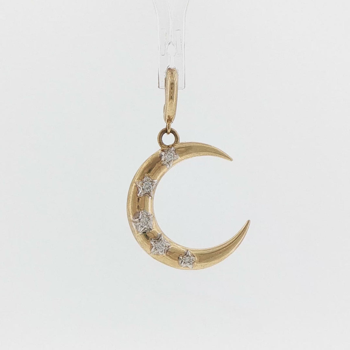 Video of a 14k yellow gold crescent moon charm with diamond stars