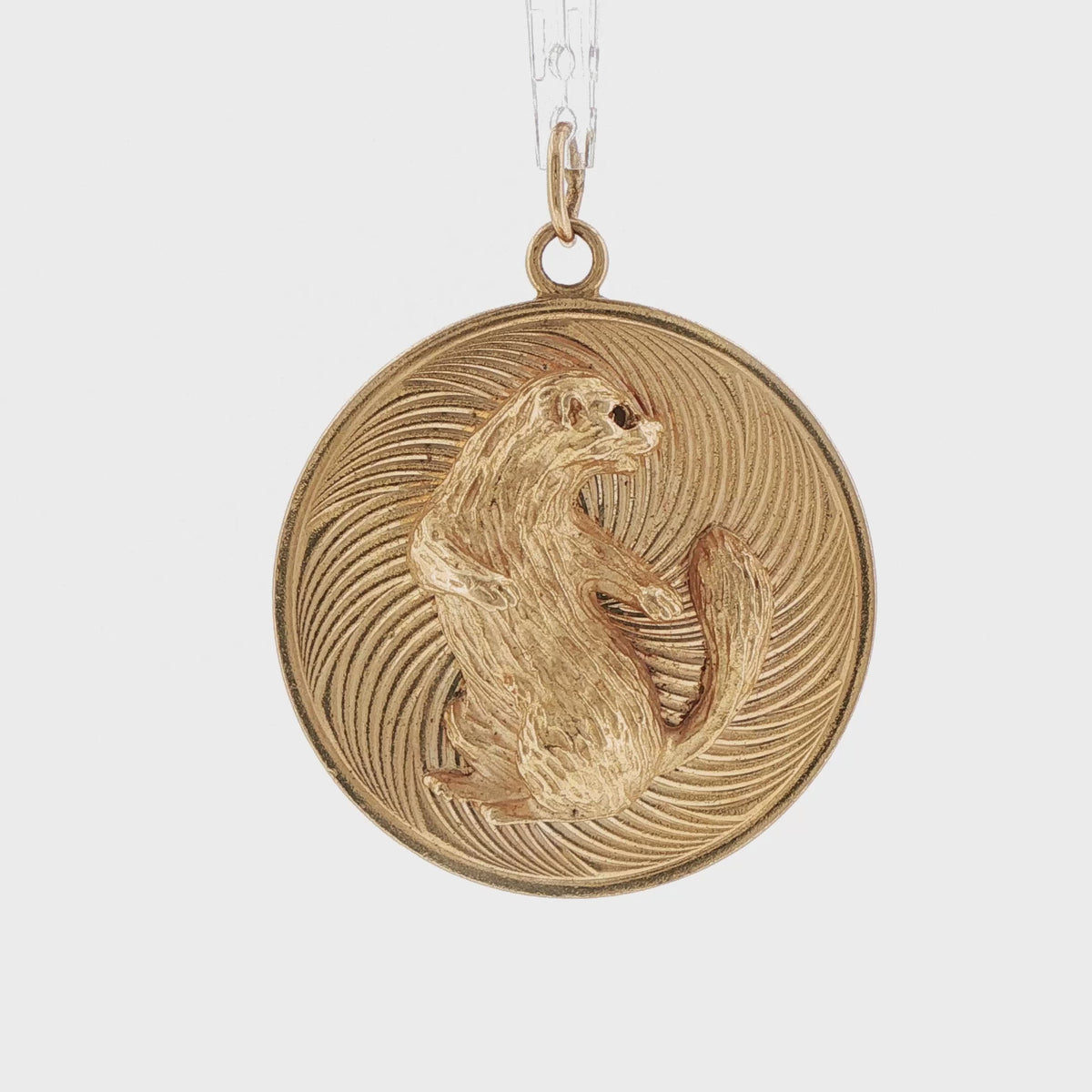 Video of a 14k yellow gold vintage engine turned squirrel charm